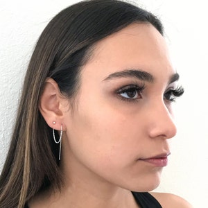 Model is wearing this small ball stud earring in the upper piercin g connected to the threader earring in the lower piercing