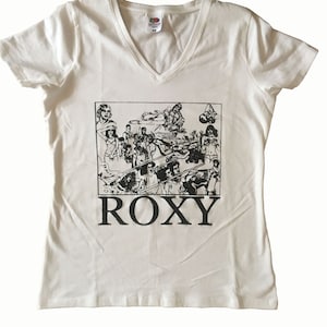 Könnte beinhalten: Weißes T-Shirt mit V-Ausschnitt und einem schwarz-weißen Grafikdruck einer Gruppe von Menschen und dem Wort "ROXY" unter dem Druck.