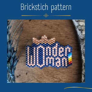 May include: A beaded brick stitch patch featuring the text "Wonder Woman" in light pink beads against a dark blue background, topped with a metallic copper crown. The right side of the patch includes a small vertical stripe of red, yellow, and blue.