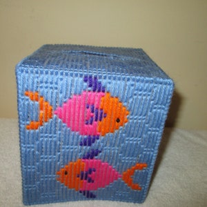May include: A blue tissue box cover with two pink and orange fish embroidered on the front.