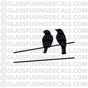 May include: Silhouette of two birds perched on a wire, a simple design for a wall decal.