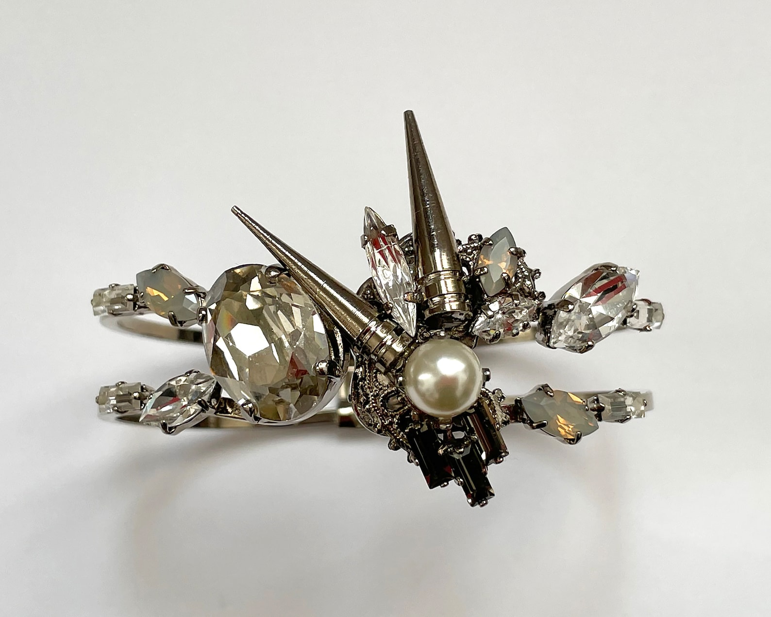 Front view of spiked pearl and crystal cuff with clear and opal Swarovski stones