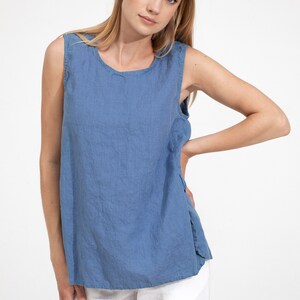 May include: A sleeveless linen top in a light blue color. The top has a round neckline and a relaxed fit.
