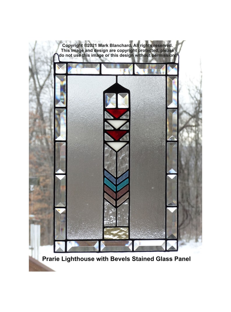 May include: A stained glass panel with a prairie lighthouse design. The lighthouse is made of clear, red, white, blue, and brown glass. The panel is surrounded by a beveled glass frame.