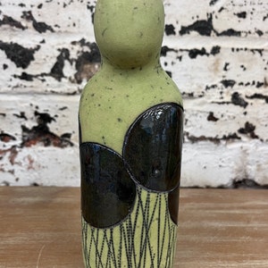 Soul Ceramic Figure Sculpture pale green with big shiny black circles