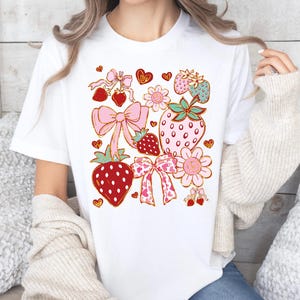Cute Strawberry Graphic T-Shirt with Bows, Spring Fashion Tee, Fruit Lover Gift, Cute Casual Wear, Summer Top, Sweetheart Shirt