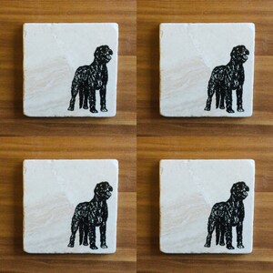 May include: Set of four white coasters with black silhouette images of a dog. Each coaster features a different pose of the dog.
