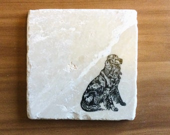 May include: A white marble coaster with a black and white illustration of a dog sitting.