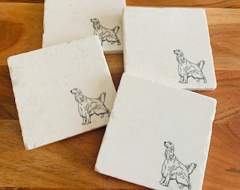 May include: Set of four white square coasters with a black line drawing of an Irish Setter dog on each coaster.