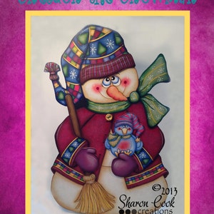May include: A hand-painted wooden snowman with a red coat, a blue and red hat, and a green scarf. The snowman is holding a broom and a small blue bird. The snowman is titled "Sheldon the Snowman" and is signed "Sharon Cook creations ©2013".