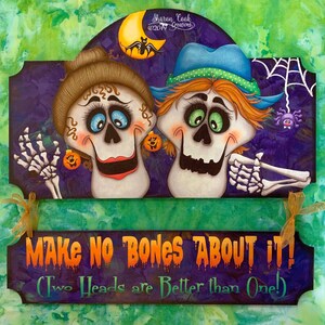 May include: A Halloween-themed wooden sign with two cartoon skeletons with colorful details. The sign reads "Make No Bones About It! (Two Heads are Better than One!)"