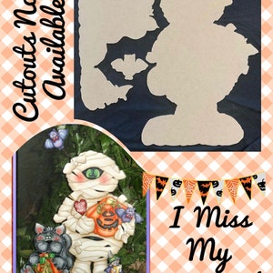May include: A painted wooden cutout of a mummy holding a pumpkin and a heart. The mummy is wearing a white bandage and has a black eye. The cutout is surrounded by bats and a black cat holding a pumpkin. The text "I Miss My Mummy!" is written in black on a banner with orange, black, and white triangles.