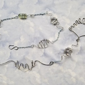Beautiful  artsy silver rain drain gutter chain.