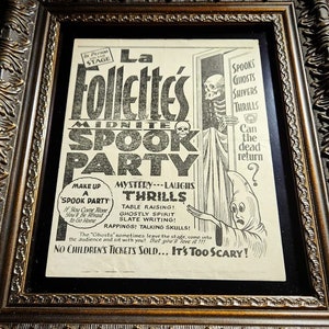 May include: A framed vintage poster advertising a "Midnite Spook Party" hosted by "La Follettes". The poster features a spooky illustration of a skeleton and a ghost with the text "Spooks, Ghosts, Shivers, Thrills. Can the dead return?" and "No Children's Tickets Sold... It's Too Scary!"