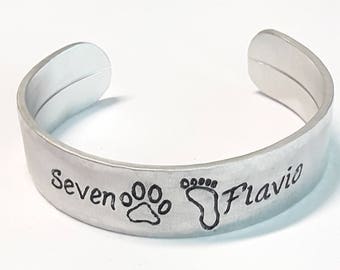 Dog and human footprint, with dog and owner name, aluminum open cuff bracelet, 12mm width, hand engraved, with satin finish.