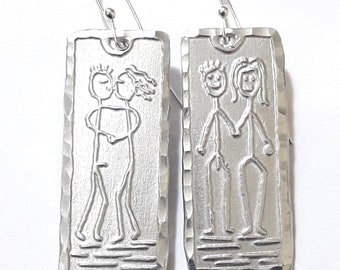 Lightweight aluminum earrings, with primitive designs of her and him naked, with custom names on the back.