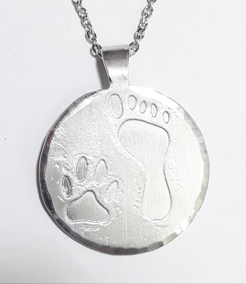 Aluminum pendant medal with a dog paw print and human footprint, with personalized text on the back. image 1