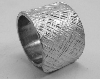 Open aluminum ring handmade forged with cross lines texture, and personalized text.