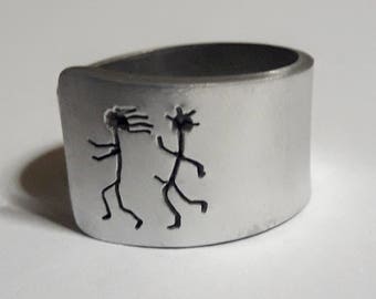 Open aluminum band ring with: He follows her, and custom text.