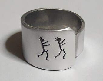 Personalized text. Open aluminum band ring with: He follows him.