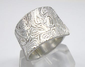 Open aluminum band ring, hand engraved, with personalized text.