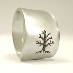 Open aluminum band ring with perforated tree parallel to the ring, and custom text.