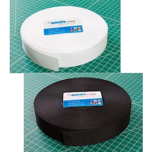 May include: Two spools of webbing, one white and one black. The spools are labeled "byannie.com" and have a website address and social media icons.