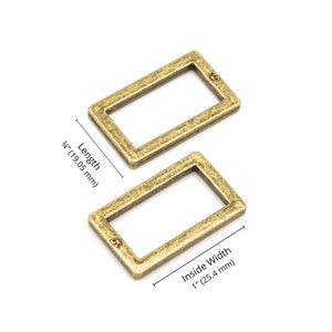 May include: Two antique gold metal rectangular rings with an inside width of 1 inch (25.4 mm) and a length of 3/4 inch (19.05 mm).