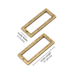 May include: Two antique gold metal rectangular rings with an inside width of 1/2 inch (13 mm) and an inside length of 1 1/2 inches (38 mm).