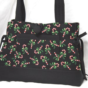 Bolso de mano, bolso de hombro, estampado de bastones de caramelo tirados sobre fondo negro
