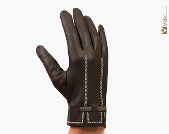 May include: Brown leather gloves with white stitching detail. The gloves have a decorative chain-like pattern on the cuff.