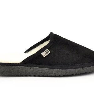 May include: Black suede slippers with a white sheepskin lining. The slippers have a rubber sole.