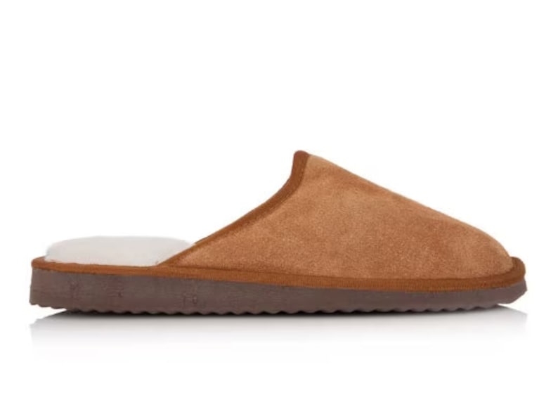 May include: A pair of brown suede slippers with a white fleece lining. The slippers have a brown rubber sole.