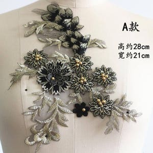May include: Black and gold floral applique with pearl accents. The applique measures approximately 28 inches tall and 21 inches wide.