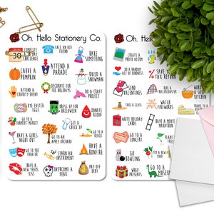 May include: Two white cards with black text and colorful illustrations. The cards list 30 things to do throughout the year, such as "Attend a Parade", "Carve a Pumpkin", "Go to a Concert", and "Plant a Tree".