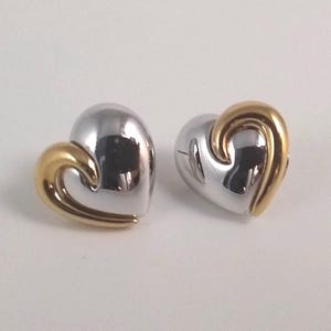 Stunning silver heart shaped earrings with a gold swirl by Park Lane, each swirl going the opposite way, vintage