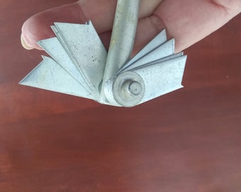Antique aluminum rotating tool, with 4 separate sections on each side that can be rotated separately.