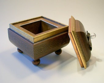 Ornate wooden box with crystal pin handle and gold painted details