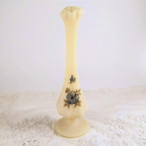 Fenton bud vase with perfect little hand painted blue flowers, signed by the artist, ruffled top in opaque satin custard glass