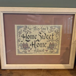 framed So This Isn't Home Sweet Home... Adjust needlework sampler