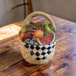 May include: A set of three ceramic mugs with a speckled, matte finish. The mugs are in shades of cream, light brown, and dark brown. Each mug has a simple, minimalist design, perfect for coffee or tea.