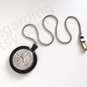 May include: A black pocket watch with a white face featuring Roman numerals and a 24-hour scale. The watch has a silver-toned snake chain attached to a metal clip. The watch face displays the text regarding.etsy.com in a light grey watermark overlay.