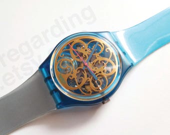 1990s 1990 Swatch watch GN107 'Stucchi' 34mm, curlicue grille open dial, pick original or colorblock strap, good unworn condition, no box