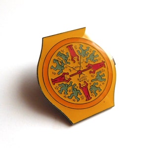May include: A yellow and orange watch face with a red and green design of dancing figures. The watch face says "Swatch Swiss" in the center.