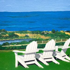 May include: Three white wooden adirondack chairs facing the ocean. The chairs are on a grassy hill overlooking a body of water and a blue sky.