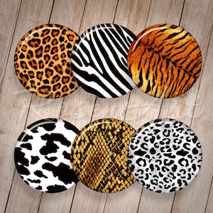 May include: Six round, colorful buttons with different animal print designs. The designs include leopard, zebra, tiger, cow, snake, and cheetah prints.
