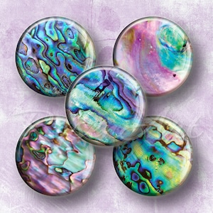 May include: Five round cabochons with iridescent abalone shell patterns in shades of blue, green, purple, and pink. The cabochons are arranged in a starburst pattern against a soft lavender background.