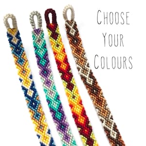 May include: Four colorful friendship bracelets with a diamond pattern are displayed against a white background. The bracelets feature a variety of colors, including blue, yellow, green, purple, red, and brown. The text "CHOOSE YOUR COLOURS" is written in black.
