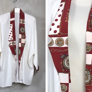 May include: A white blazer with a red, white and gold patterned collar. The collar has a chequered pattern, polka dots and ornate designs.