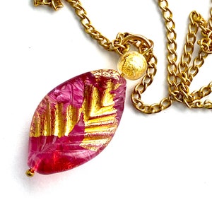 Murano glass pendant with pink and gold Murano Glass leaf bead and gold chain.